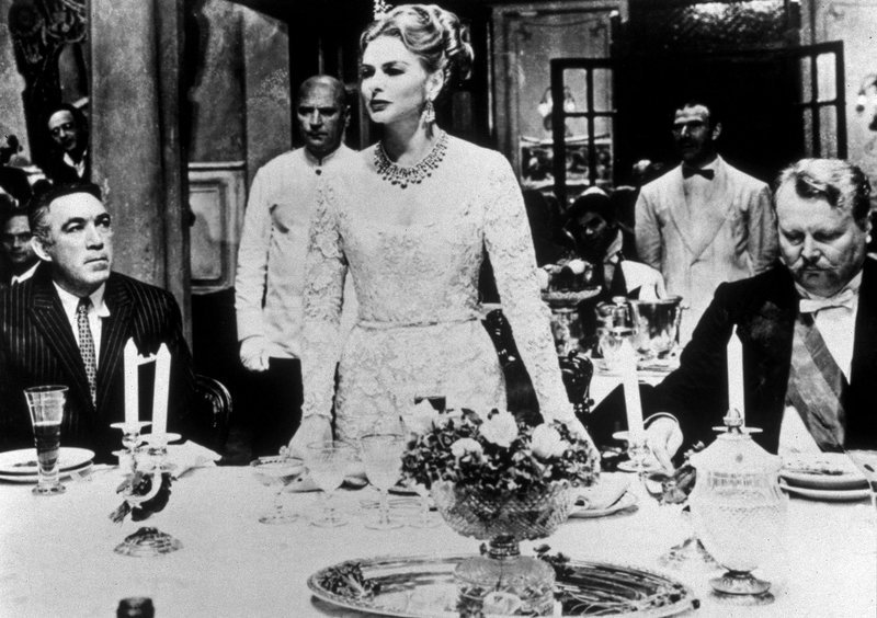 Die Millionärin Karla Zachanassian (Ingrid Bergman) will bei ihrem Besuch in ihrer Heimatstadt Güllen (l. ihr einstiger Liebhaber Serge Miller [Anthony Quinn], r. Bürgermeister [Ernst Schröder]) Wiedergutmachung für einstiges Unrecht. – Bild: MDR/​20th Century Fox