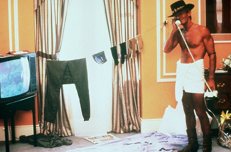 In New York schlägt Crocodile Dundee (Paul Hogan) sein Lager in einem noblen Hotelzimmer auf … – Bild: Puls 4
