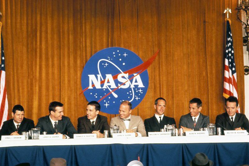 Auf einer PK stellt die NASA die sieben Piloten des Mercury-Programms vor (v.l.): Gus Grissom (Fred Ward), Gordon Cooper (Dennis Quaid), Deke Slayton (Scott Paulin), John Glenn (Ed Harris), Al Shepard (Scott Glenn), Wally Schirra (Lance Henriksen). – Bild: ARTE France 