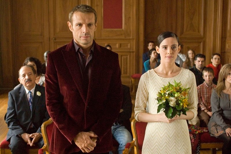 Im Tausch gegen das Austragen des Babys geht Manu (Lambert Wilson) mit Fina (Pilar López de Ayala), die illegal in Frankreich ist, eine Scheinehe ein. – Bild: ARTE F /​ © Nord-Ouest Films