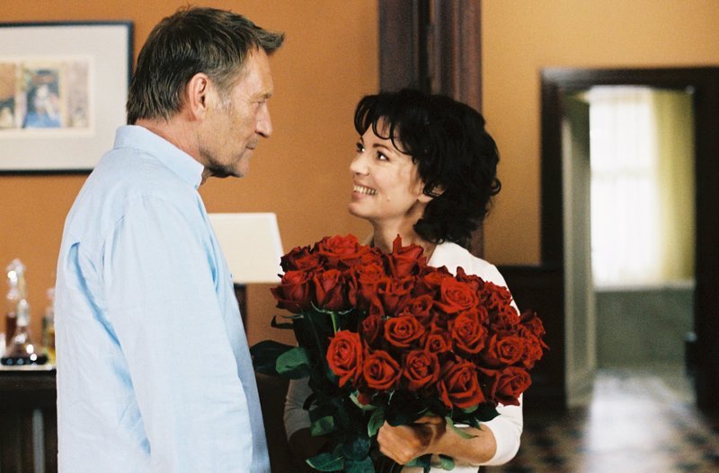 Alma (Iris Berben) bekommt von ihrem Mann Ben (Matthias Habich) zur Silberhochzeit rote Rosen geschenkt. – Bild: BR/​MOOVIE/​Stefanie Kulbach