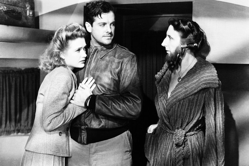Als Pat Martin (Priscilla Lane, li.) und Barry Kane (Robert Cummings, Mi.) bei einer Zirkustruppe Unterschlupf suchen, erweist sich die vollbärtige Lorelei (Anita Sharp-Bolster, re.) als mitfühlendes Herz. – Bild: ZDF / © 1942 Universal /J.A.Valentine Als Pat Martin (Priscilla Lane, li.) und Barry Kane (Robert Cummings, Mi.) bei einer Zirkustruppe Unterschlupf suchen, erweist sich die vollbärtige Lorelei (Anita Sharp-Bolster, re.) als mitfühlendes Herz. – Bild: ZDF / © 1942 Universal /J.A.Valentine