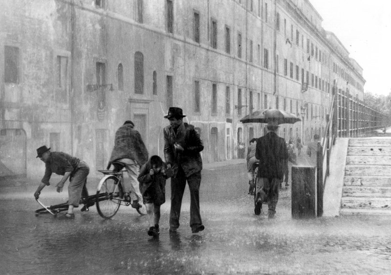 Sintflutartige Regenfälle erschweren Antonio (Lamberto Maggiorani, 2.v.r.) und seinem Sohn Bruno (Enzo Staiola, 3.v.l.) die Suche nach dem gestohlenen Fahrrad. – Bild: MvH – ArtDesign /​ Barum 2005 ; fuer ARTE G.E.I.E.