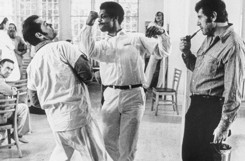 Milos Forman (re.) bei den Dreharbeiten zu seinem Film „Einer flog über das Kuckucksnest“ mit den Darstellern Nathan George (Mi.) und Jack Nicholson (li.): Der Film erschien 1975 und spielt in einer Psychatrie. – Bild: Pavel Jiras /​ © Pavel Jiras