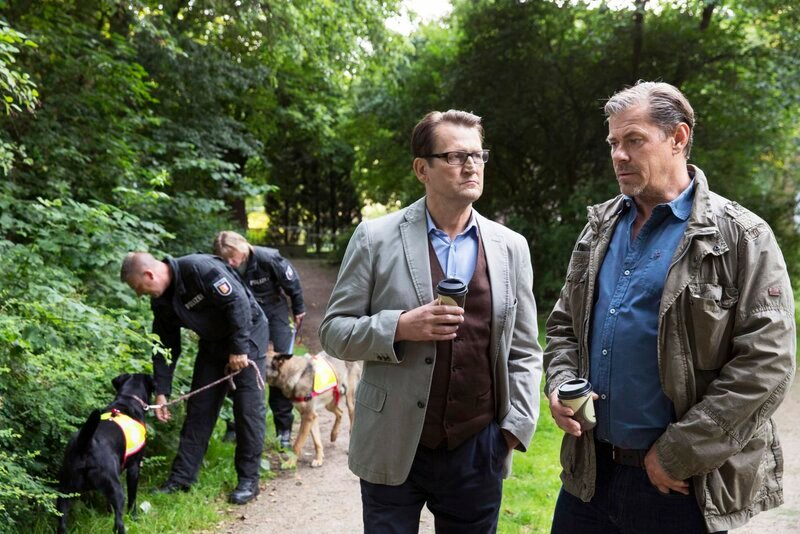 Lars (Ingo Naujoks, 2.v.r.) und Finn (Sven Martinek, r.) lassen mit Hunden nach dem verschwundenen Baby suchen. – Bild: WDR/​ARD/​Georges Pauly