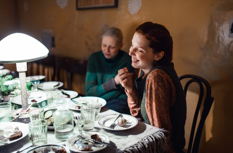 Die schüchterne Ija (Viktoria Miroschnitschenko, li.) und die selbstbewusste Mascha (Vasilisa Perelygina, re.) sitzen zusammen am Tisch. – Bild: arte