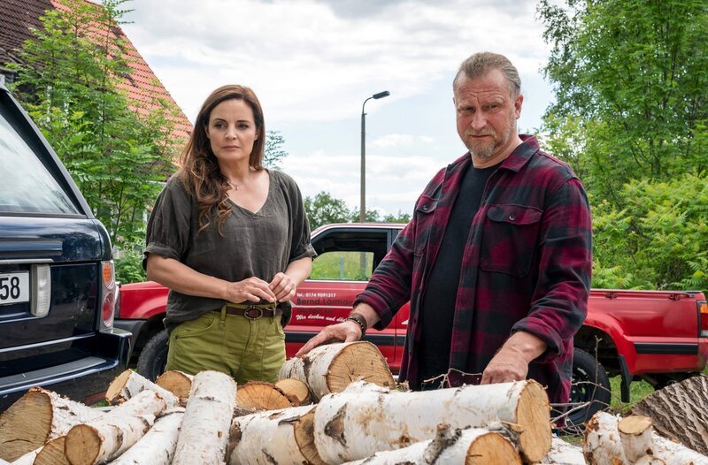 Susanne Mertens (Elisabeth Lanz, l.) ist wenig begeistert, als Alpakafarmer Mike Redmann (Matthias Komm, r.) mit einer Holzlieferung vorm Wochenendhaus steht. Aber was ist ihr Problem? – Bild: ARD/​Steffen Junghans