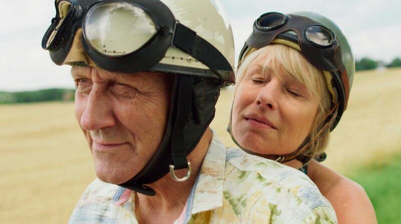 Charlotte und Paul mit der Vespa unterwegs (Karl Kranzkowski und Corinna Harfouch). – Bild: SR/Almode Charlotte und Paul mit der Vespa unterwegs (Karl Kranzkowski und Corinna Harfouch). – Bild: SR/Almode