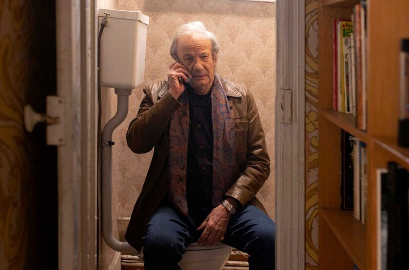 Serge Alvaro (Patrick Chesnais) hat sich telefonierend in der Toilette versteckt. – Bild: NDR/​Philippe Le Roux/​Manuelle Toussaint