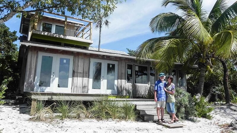 The homebuyers of the first home, Howard and Cyndy Livingston posing next to it. – Bild: Destination America /​ Discovery Communications
