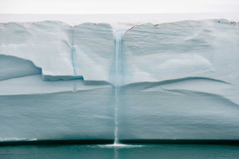 Melting ice forms waterfall falling into sea over edge of glacier wall due to global warming in Northern Arctic. Climate crisis and breakdown – Bild: shutterstock