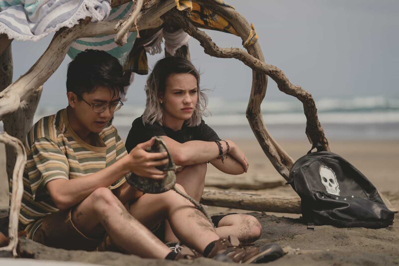 Caleb (Joshua Tan, l.) hat eine alte vergrabene Schiffsglocke am Strand entdeckt, nachdem er Issie (Macey Chipping, r.) offenbart hat, dass er homosexuell ist. – Bild: ZDF/​Matt Klitscher