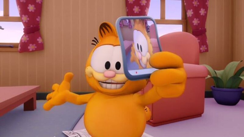 Garfield hat Jons neues Smartphone als Spielzeug entdeckt und dreht einige Videos damit. Er filmt Jon bei ein paar tollpatschigen Situationen. – Bild: HR/​DARGAUD MEDIA