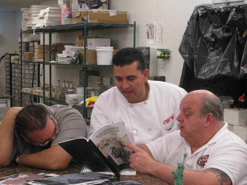 Frankie, Mauro and Buddy sit around table with State of Liberty figurine. – Bild: Copyright: Discovery Communications, Inc. – Promote program, network, DCL and DCL affiliated businesses in all media throughout the world in perpetuity