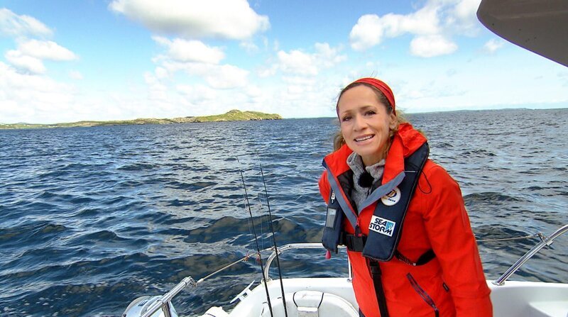 Bei einer Bootstour vor der Küste der Insel „Lewis and Harris“ auf den Äußeren Hebriden“ erlebt Tamina Kallert das typische Schottland-Wetter: Auf einen kräftigen Regenschauer folgt Sonnenschein. – Bild: BR/​WDR/​REDAKTIONELLE VERÖFFENTLICHUNG DRITTER