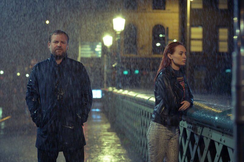 Im strömenden Regen begegnet Lloyd (Stephen Jones) Áine (Elva Trill), die allein auf der Grattan Bridge steht. – Bild: ZDF und Deadpan Pictures.
