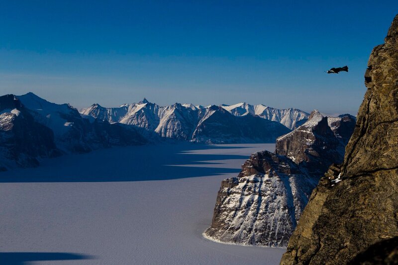Overlooking Sam Ford Fjord, Jim Mitchell leaps from Ottawa Peak in his wingsuit on Baffin Island, Canada. (credit: Krystle Wright) – Bild: Krystle Wright /​ Krystle Wright /​ Krystle Wright