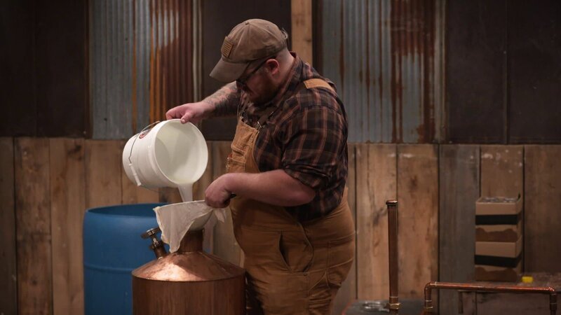 Gian pouring moonshine into bucket. – Bild: DMAX
