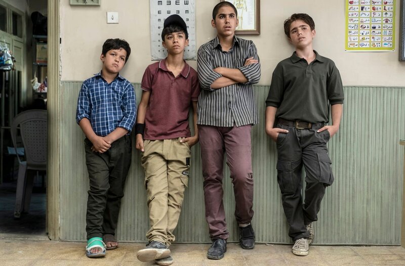 Abolfazl (Abolfazl Shirzad, l.), Reza (Mani Ghafouri, 2.v.l.), Mamad (Mahdi Mousavi, 3.v.l.) und Ali (Rouhollah Zamani) wollen sich in der „Sun School“ anmelden, weil sie unter der Schule einen Schatz vermuten. – Bild: MDR/Majidi Film Production Abolfazl (Abolfazl Shirzad, l.), Reza (Mani Ghafouri, 2.v.l.), Mamad (Mahdi Mousavi, 3.v.l.) und Ali (Rouhollah Zamani) wollen sich in der „Sun School“ anmelden, weil sie unter der Schule einen Schatz vermuten. – Bild: MDR/Majidi Film Production