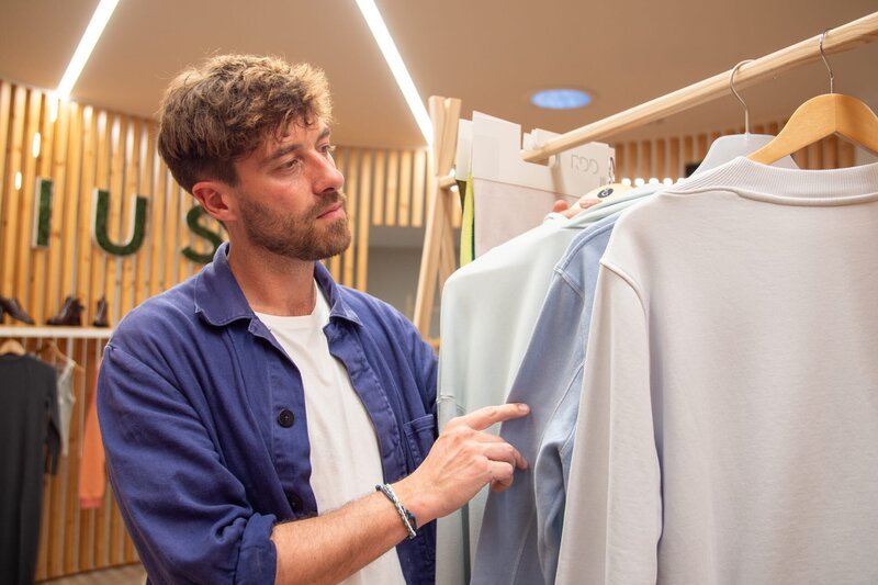 Frederik Fleig schaut sich die nachhaltig gefertigte Kleidung bei Valerius in Porto an – Bild: ZDF und Mathilda Kühne./​Mathilda Kühne