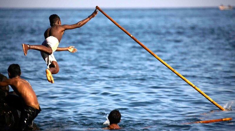 Bei den Walfängern von Lamalera: Jugendliche üben mit einer Bambusstange, wie man eine Harpune wirft. – Bild: ZDF und NDR/​Philipp Abresch.