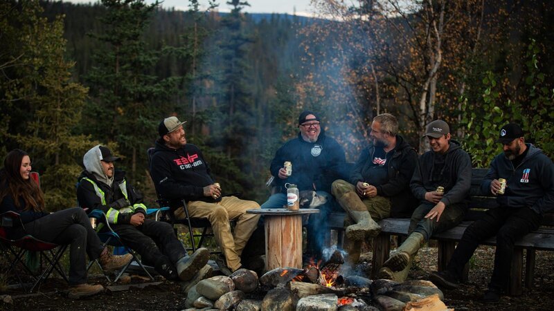 Ness crew all gathered around fire pit for gold weigh – Bild: Warner Bros. Discovery