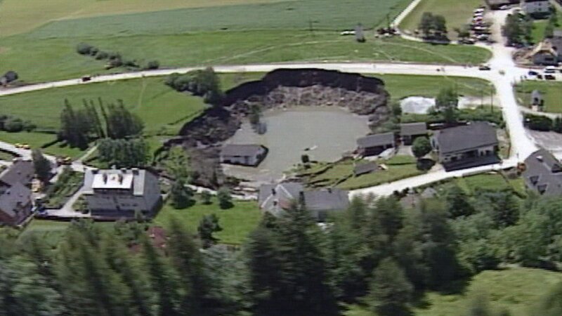 Nach dem Grubenunglück tat sich an der Oberfläche ein riesiger Krater auf. – Bild: ORF Nach dem Grubenunglück tat sich an der Oberfläche ein riesiger Krater auf. – Bild: ORF
