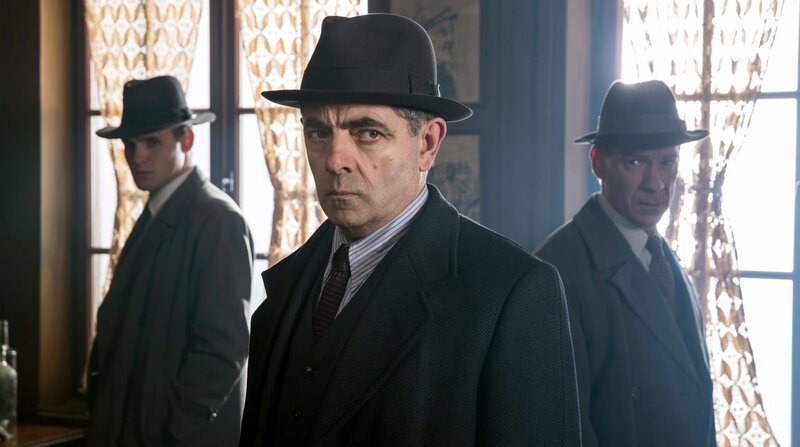 Kommissar Maigret (Rowan Atkinson) und seine Inspektoren Lapointe (Leo Staar, li.) und Janvier (Shain Dingwall, re.) nehmen das verlassene Bistro des Ermordeten unter die Lupe. – Bild: ZDF und ARD Degeto/​Peket CoProduction Ltd..
