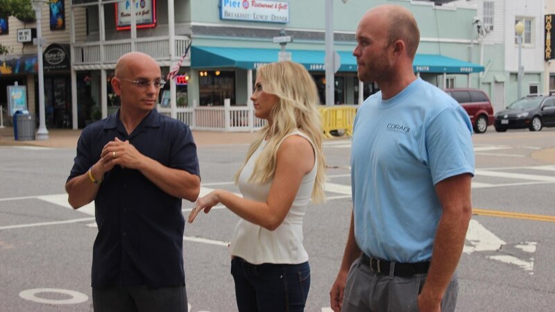 Host Anthony Melchiorri, designer Britany Simon, and the lead from their contracting team present the renovated guest room to the owners. – Bild: The Travel Channel, L.L.C.