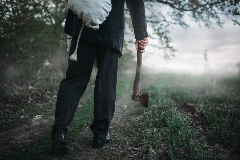 Slayer with an axe carries the victim’s body – Bild: Shutterstock