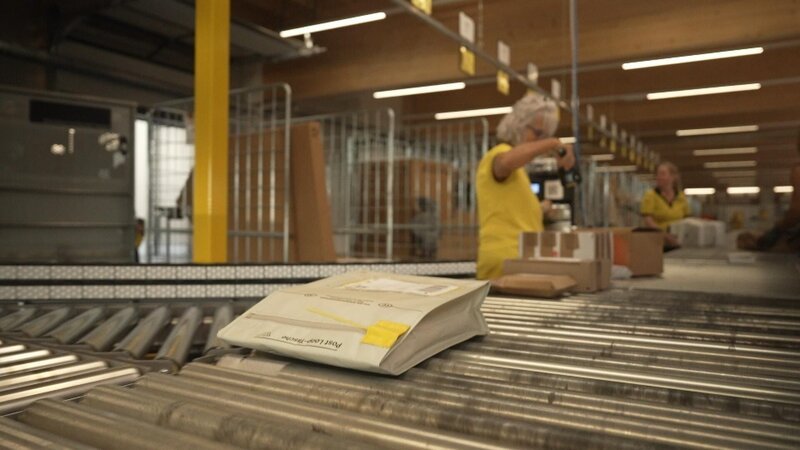 Über 1000 Pakete am Tag bearbeiten die Mitarbeitenden der österreichischen Post jeden Tag – pro Kopf. Neue, wiederverwendbare Versandtaschen sollen die Paketflut nachhaltiger machen. – Bild: Jasper Granderath