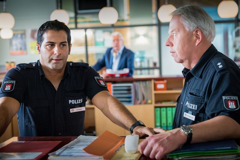 Tarik (Serhat Cokgezen, l.) macht sich Sorgen, dass Claudia dem Polizeijob nach ihrem Überfall nicht mehr gewachsen ist. Wolle (Harald Maack, r.) rät ihm, ihr den Rücken zu stärken. – Bild: Boris Laewen