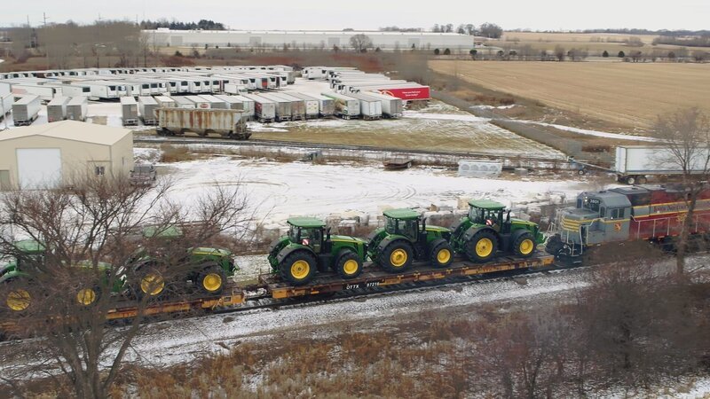 Aerial shot of tractors loaded onto train. – Bild: The National Geographic Channel