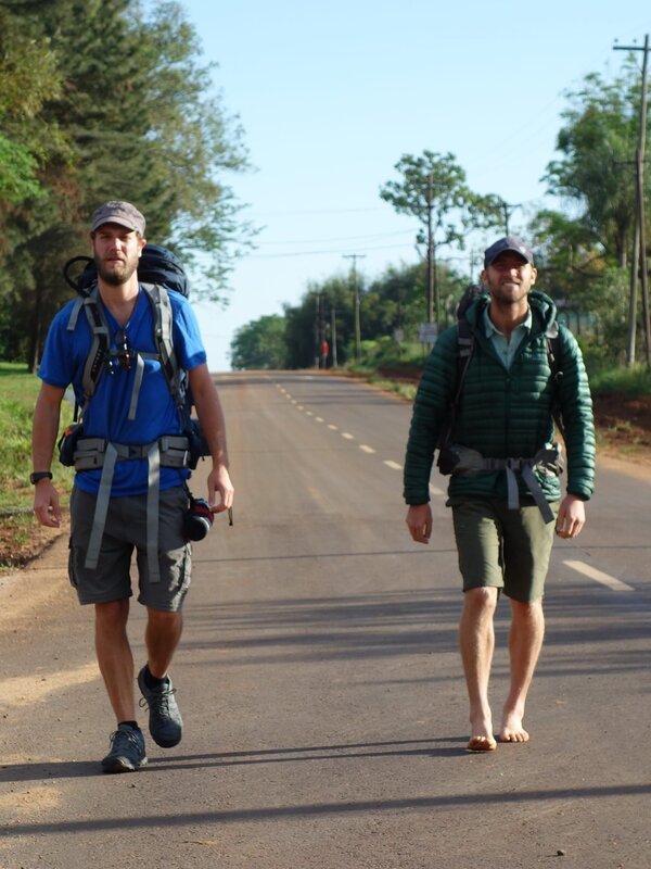 Rob Greenfield and James Levelle walking down the road in Iguazu, Argentina. – Bild: Discovery Communications