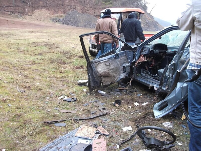 Chris and Paul check car wreckage after firing cannons at cannon school at the NSSA Headquarters. – Bild: National Geographic Society