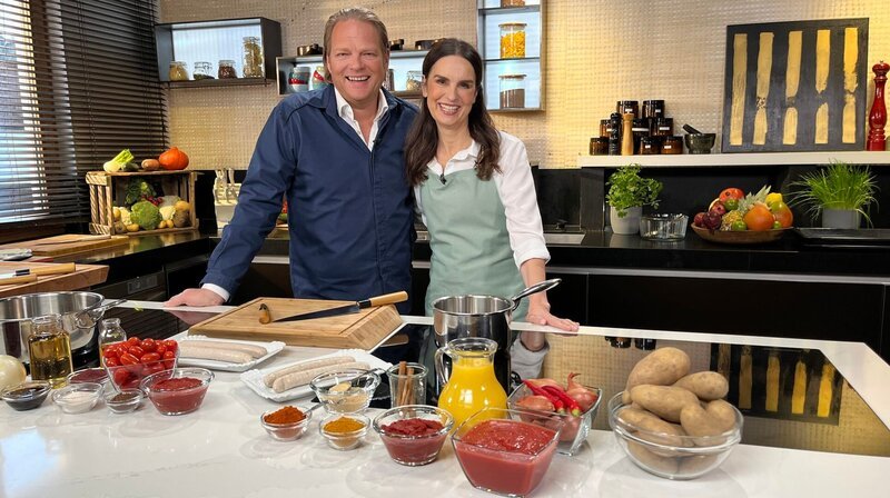 Zusammen mit Foodbloggerin Emmi Prolic bereitet Björn Freitag (l) verschiedene Varianten der Currywurst zu. – Bild: WDR/​solis TV/​Joshua Stolz