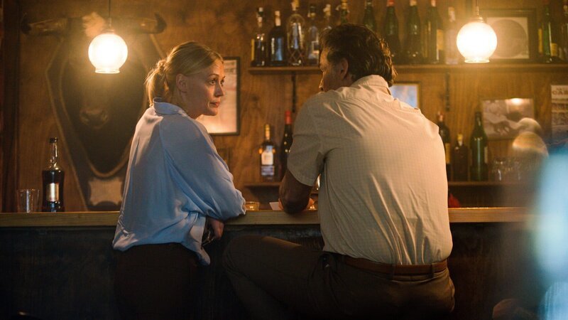 Miranda (Elen Rhys) sitzt mit Manu Alzamora (Pablo Scola) in einer Bar, um über den Mordfall in einer Stierkampfarena zu sprechen. – Bild: Giacomo Neri