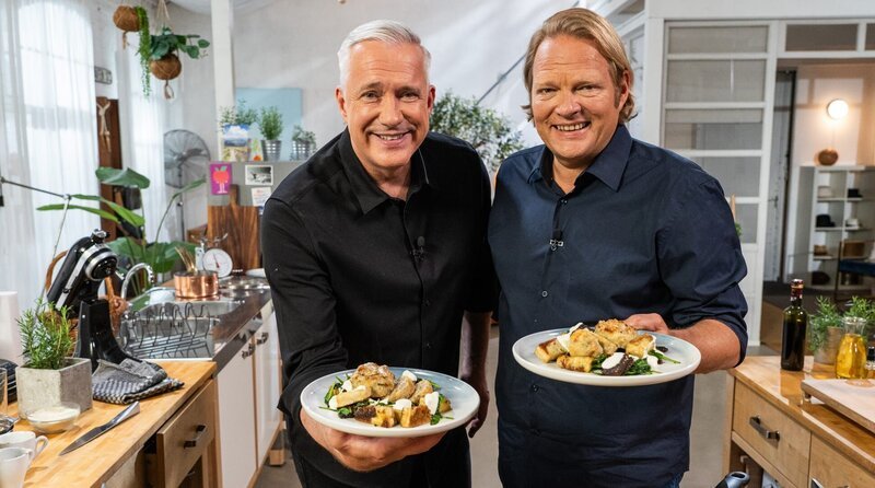 Aus sechs Restzutaten haben Alexander Herrmann (links) und Björn Freitag ein einfaches und köstliches Fusionsgericht zubereitet: Schaum-Pflanzerl mit Spinat-Brot-Salat. – Bild: WDR/​BR/​2Bild TV.Events & Media GmbH/​Daniel Bechthold