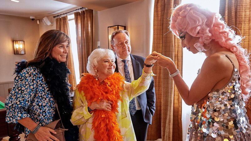 Sarah Barnaby (Fiona Dolman, l.) und Rechtsmedizinerin Fleur Perkins (Annette Badland, 2.v.l.) sind fasziniert von Malik Paynes (Felix Kai, r.) Darbietungen als Dragqueen. John Barnaby (Neil Dudgeon, 2.v.r.) kann diesem Zauber nur wenig abgewinnen. – Bild: Mark Bourdillon/​All3Media