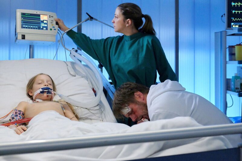 Clemens Körner (Kai Scheve, rechts) spukt mittlerweile Blut, verweigert aber immer noch jede Untersuchung oder Behandlung. Er wird nicht von der Seite seiner kleinen Tochter Julia (Frida Elise Pechstein, links) weichen. Oberschwester Arzu (Arzu Bazman) muss an ihre Kinder denken und in einer Übersprunghandlung schaltet sie die Kontrollgeräte von Julia ab. – Bild: BR/​MDR/​Saxonia Media Filmproduktions GmbH/​Sebastian Kiss /​ Sebastian Kiss