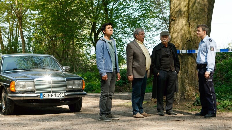 In einem verlassenen Auto werden Blutspuren gefunden, aber keine Leiche. Hui Ko (Aaron Le, l.), Günter (Wolfgang Winkler. 2.v.l.) und Edwin Bremer (Tilo Prückner, 2.v.r.) lassen sich von Benz (Dominik Klingenberg, r.) die Spuren zeigen. – Bild: ARD/​Kai Schulz
