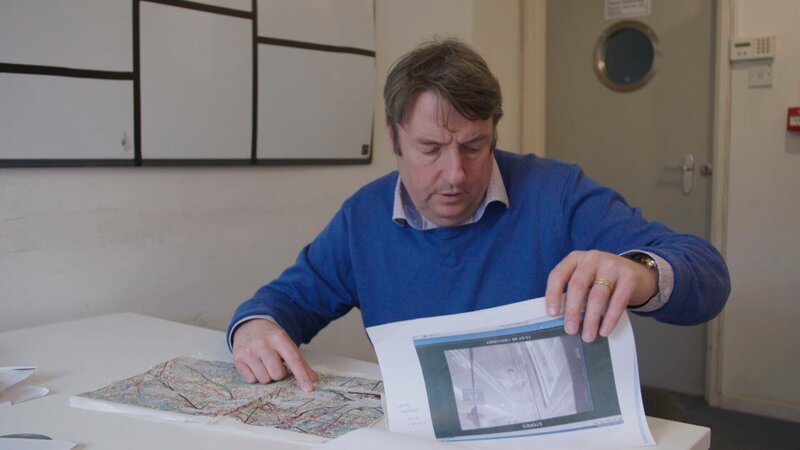 Ein Mann prüft eine Karte. – Bild: cinflx /​ Crime + Investigation /​ Rare Television Ltd.