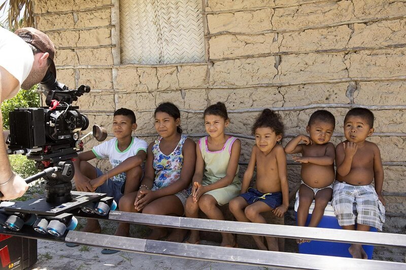 Camera person filming village children. – Bild: Discovery Communications