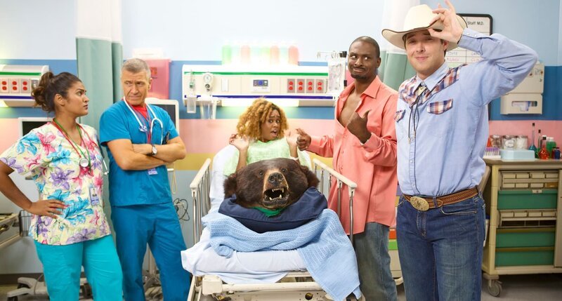 A woman with a bear head in her lap at the hospital. – Bild: TLC