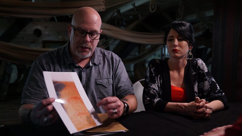 Dave Schrader is with Cindy Kaza as he presents a photograph of the bite mark he sustained during the investigation of the USS Constellation in Baltimore, MD, as seen on Travel Channel’s The Holzer Files – Bild: Scripps