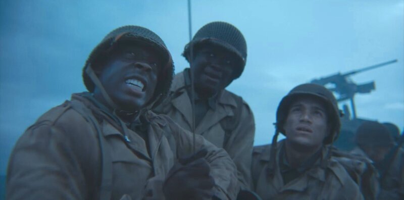 Soldaten helfen Corporal William Dabney (gespielt von Joshua Riley) beim Aufsteigen des Sperrballons in einer Szene einer historischen Nachstellung des Zweiten Weltkriegs für „Erased: WW2’s Heroes of Color“. Corporal Dabney diente mit dem 320th Barrage Balloon Battalion am D-Day. – Bild: National Geographic /​ Disney