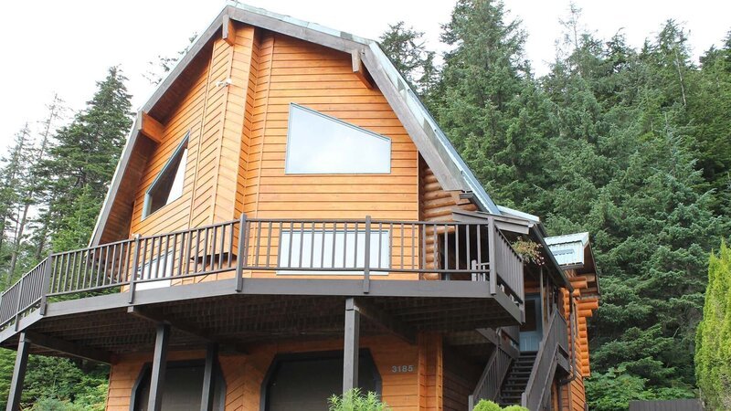 Exterior, house, at Lodge House, complete with wood siding, wrap around deck, two car garage, stairs up to front door, near Juneau, Alaska, as seen on Great American Country’s Living Alaska – Bild: Great American Country/​Scripps Networks, LLC.