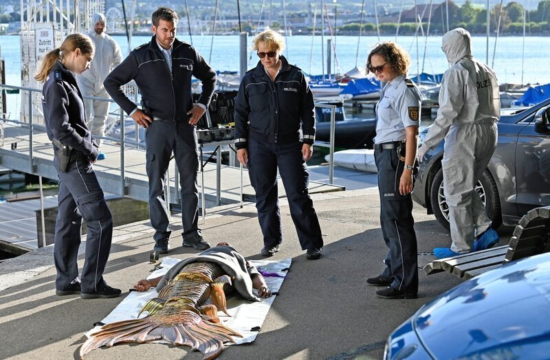 Nele Fehrenbach (Floriane Daniel, M.), Julia Demmler (Wendy Güntensperger, 2.v.r.) und Jakob Frings (Max König, 2.v.l.) betrachten die tote Nixe Lisa Bertram (Cindy Guyot, v.). – Bild: ORF/​Bavaria/​ARD/​SWR/​Laurent Trümper