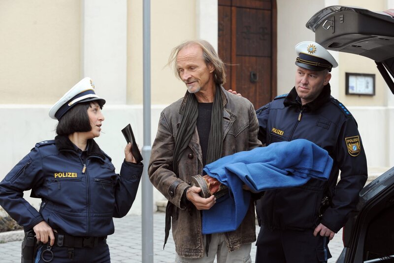 Josephine nimmt Sascha gleich wegen zweier (vermeintlicher) Delikte fest. Von links: Josephine Drechsler (Mira Mazumdar), Alexander „Sascha“ Wagenbauer (Eisi Gulp), Polizist Manfred Haas (Michael Dietmayr). – Bild: BR/​Marco Orlando Pichler