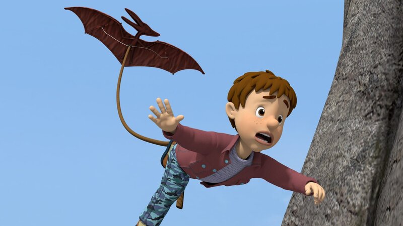 Norman hat seinem Cousin Derek einen Streich gespielt. Dass Derek an einem Pterodactylus-Drachen davonfliegt, hat er aber nicht geplant. – Bild: KiKA/​HIT Entertainment